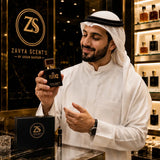 Man holding a Zavya Scents perfume bottle in a store setting